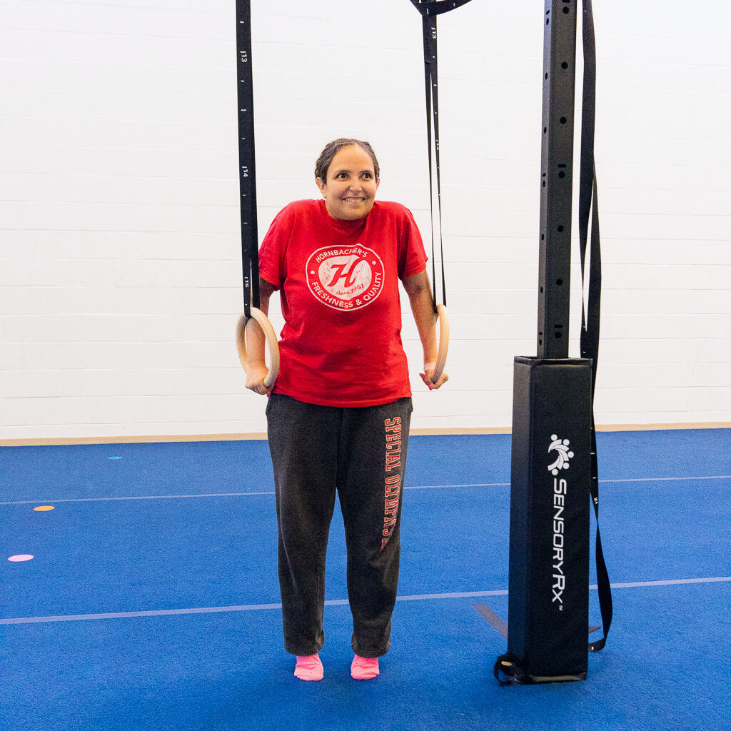 a young woman performing modified gymnastics on the rings