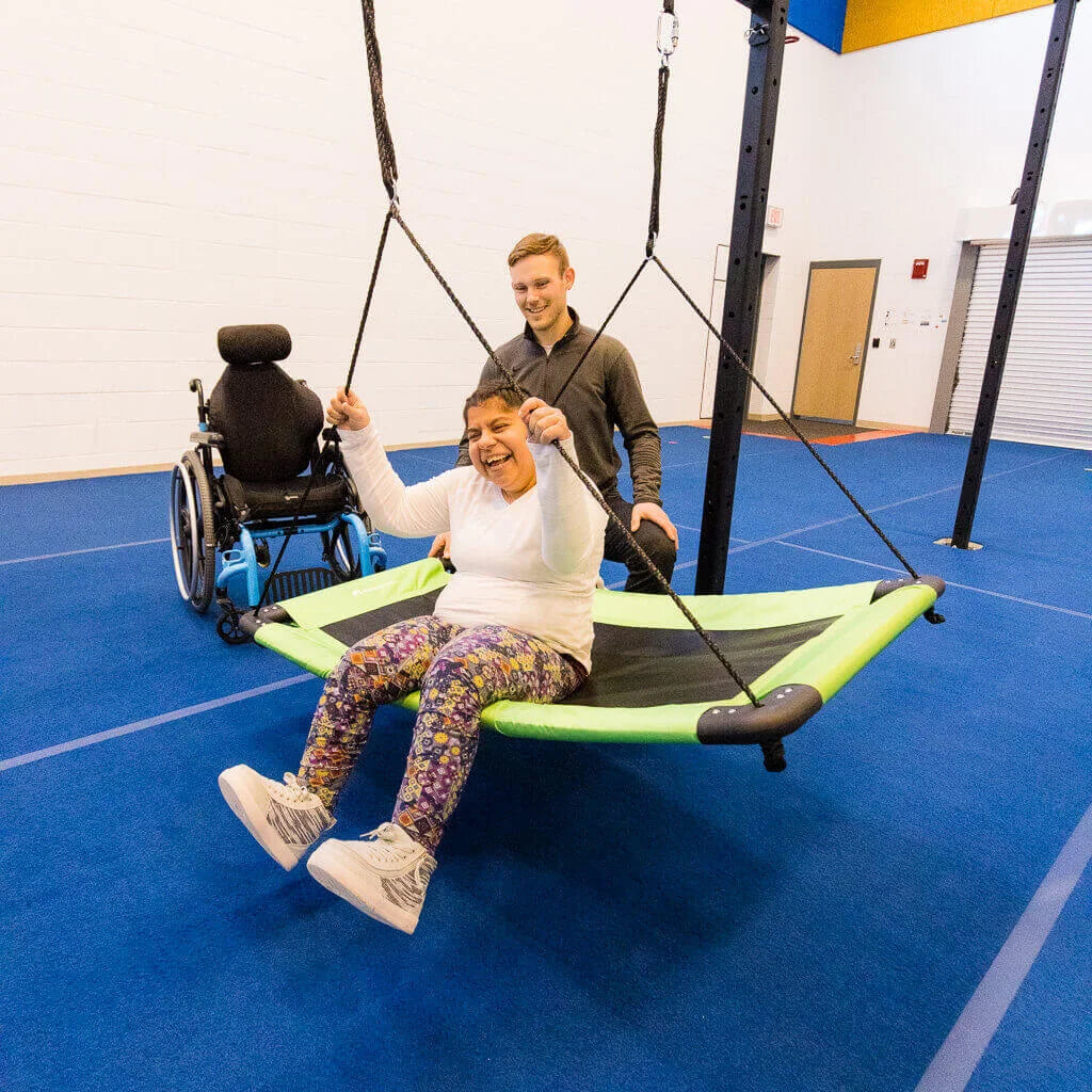 A woman with cerebral palsy on a swing