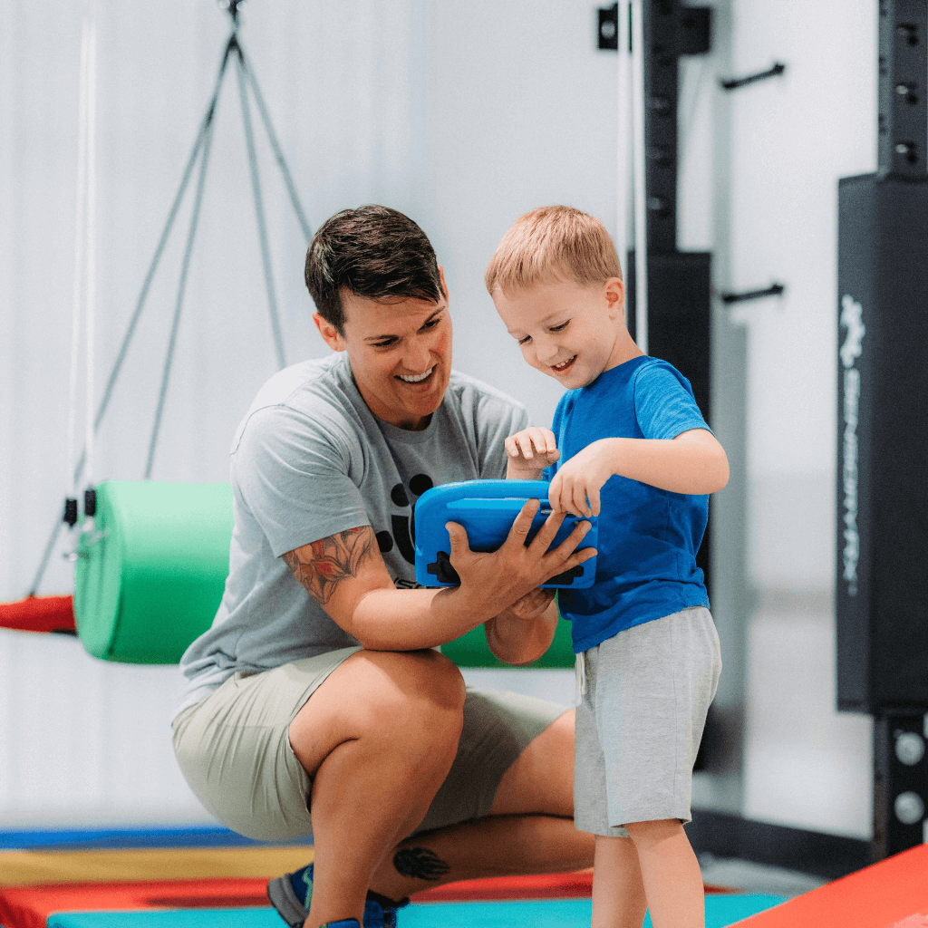 A parent and child viewing ClimbRx sensory programing on a tablet device.