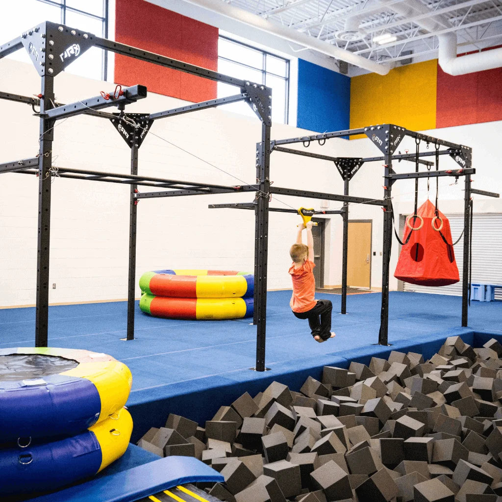 A boy riding a zipline in a sensory gym