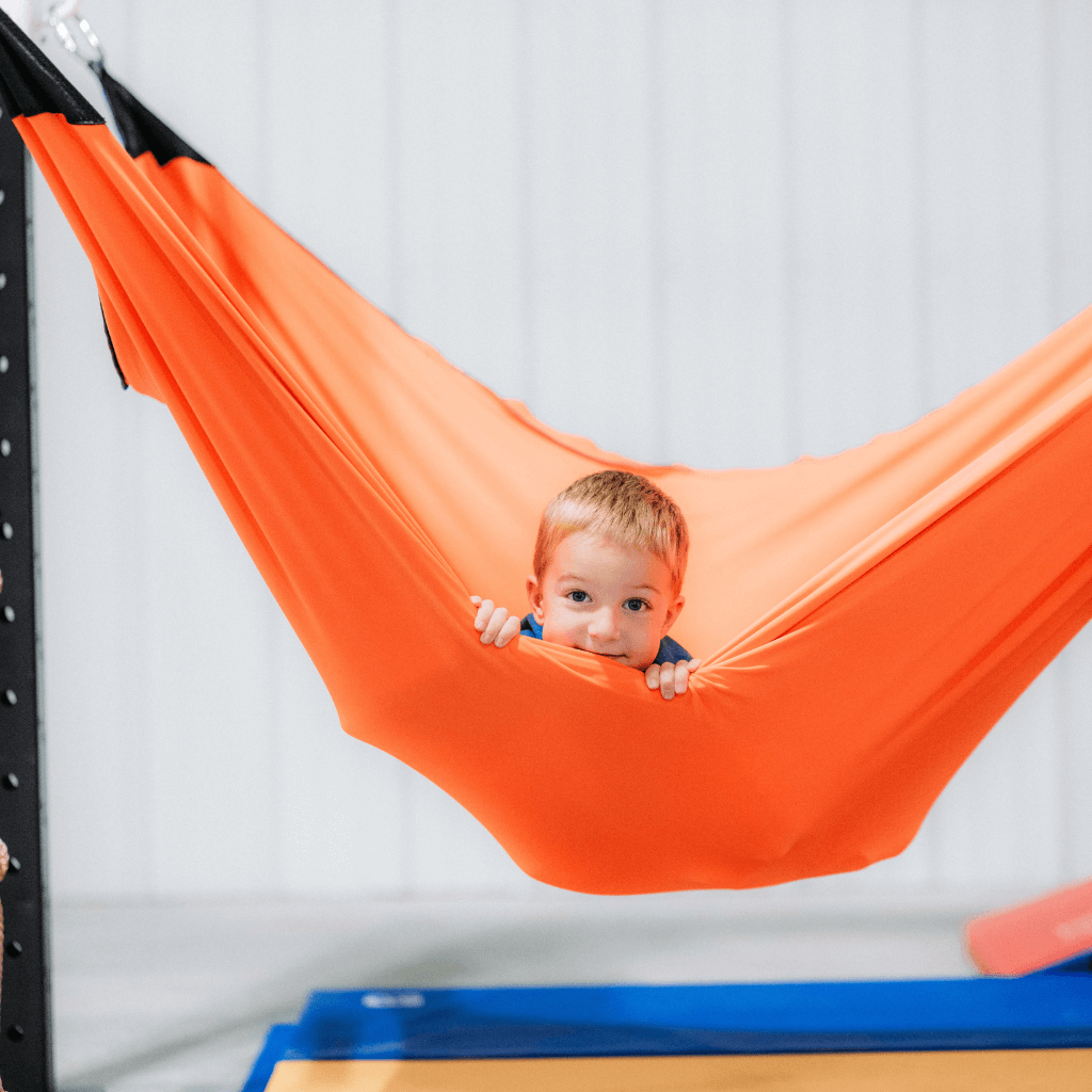 A child in a spandex lycra hammock swing