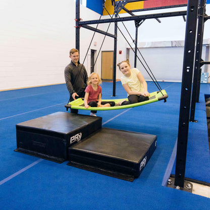 Young girls playing on a sensory platform swing