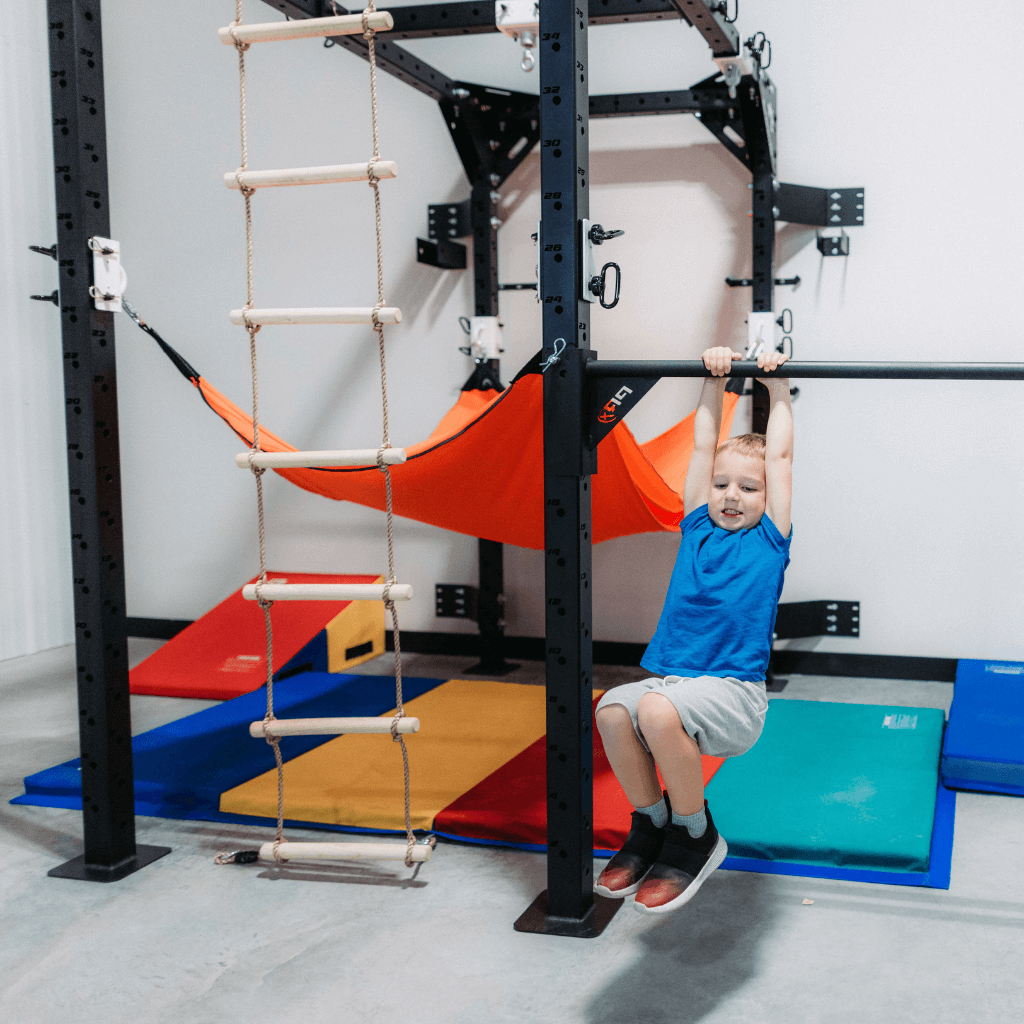 A child playing on a home sensory gym