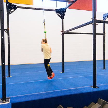A girl hanging on a sensory climbing rope